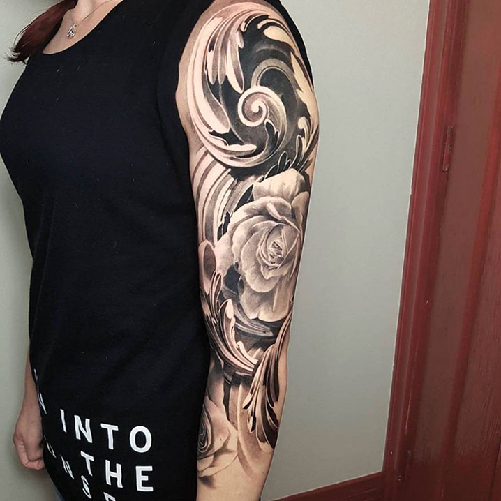 Black and grey tattoo sleeve on woman