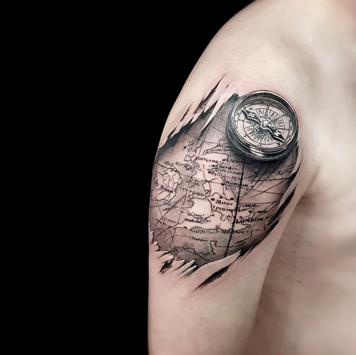 Realistic old fashioned pocket watch on mans shoulder tattoo