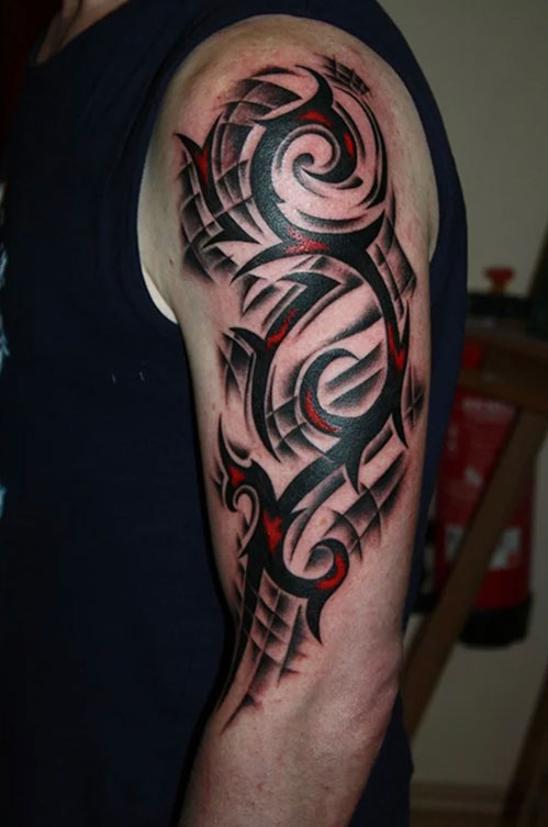 Red and Black Tribal tattoo sleeve on mans arm